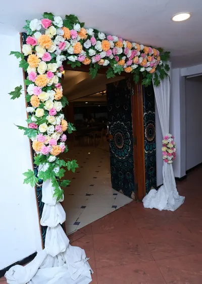 Another angle of the floral doorway decoration, showing how it enhances the entrance to the main event hall.