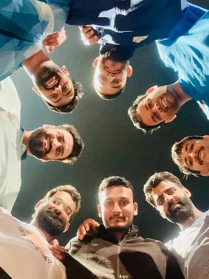 A creative huddle shot with the NIS squad. This perspective shows the unity and trust we build within the team. We always have each other's backs.