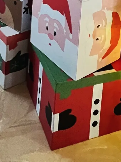 Adorable gift boxes decorated to look like Santa and his elves.