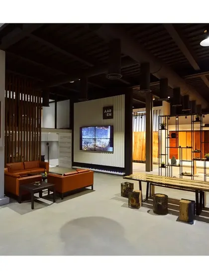 An inviting commercial interior with rustic wooden furniture and display shelves, creating a warm and comfortable ambiance for clients.