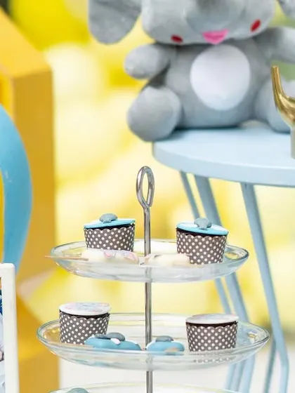 A closer look at the dessert table from the baby elephant party. I love incorporating personal touches, like framed photos of the birthday boy from his first year, to make the celebration even more meaningful.