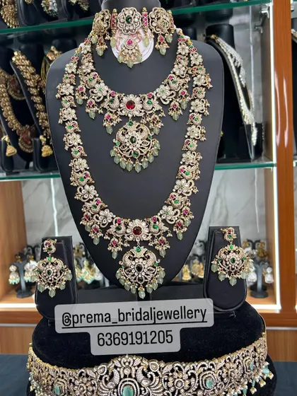 A grand uncut stone set with a mix of red, green, and pastel green stones.