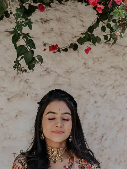 A serene portrait of the bride taking a quiet moment for herself amidst the wedding festivities.