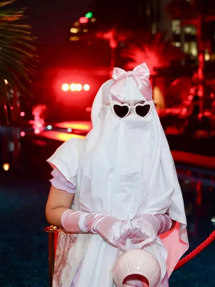 A creative and cute ghost costume, complete with heart-shaped sunglasses. Halloween is for everyone.