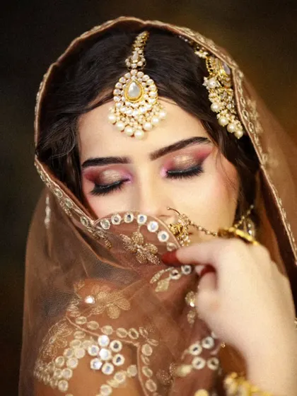 A shy, candid-style pose that captures the emotion of the moment, with makeup that looks flawless and natural.