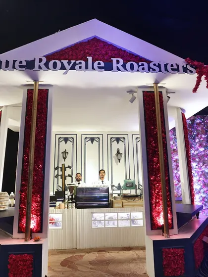 The "Rue Royale Roasters" coffee bar, a bespoke station designed to serve artisanal coffee. We can provide specialized beverage stations to complement your menu and elevate the guest experience.