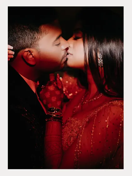 An intensely romantic and passionate kiss captured with dramatic red lighting. This photo from an engagement party is all about capturing the fire and chemistry.
