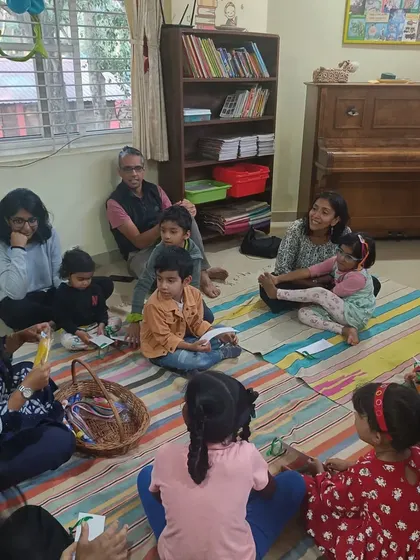 A candid moment during a craft activity, with parents helping their little ones. We believe in learning together as a community.