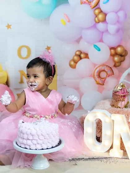 All smiles and frosting. We provide a beautifully decorated setup and a yummy cake for our first birthday cake smash sessions.