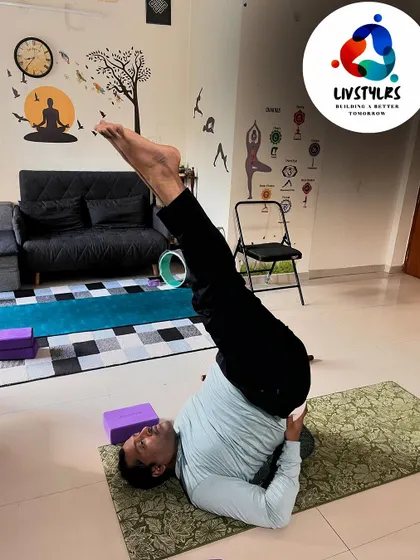 A client practices Sarvangasana (Shoulder Stand), a foundational inversion in yoga that benefits the thyroid gland and calms the nervous system.
