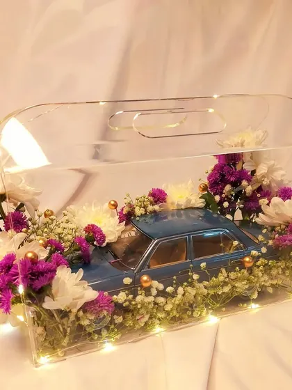 We believe in creating truly unique gifts that leave a lasting impression. This custom floral hamper featuring a Mercedes-Benz collectible car is a perfect example of how we can tailor a gift to any specific interest or theme.