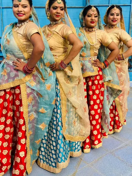 Our dancers lined up in their vibrant red and blue folk costumes. We pay close attention to detail, from the choreography to the traditional outfits, for an authentic performance.