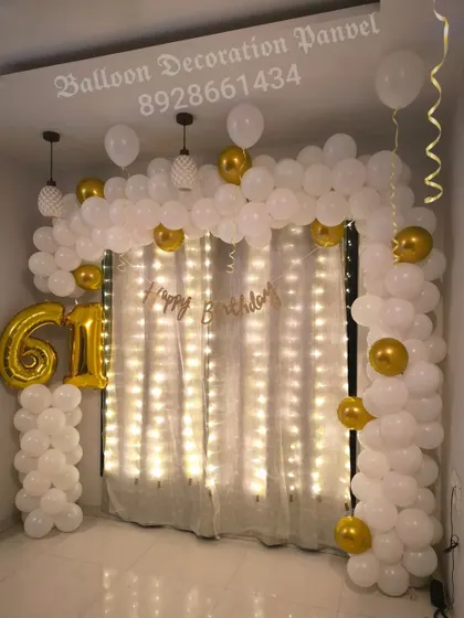 A duplicate view of the classy 61st birthday decoration, showcasing the beautiful combination of white and gold balloons with warm lighting.