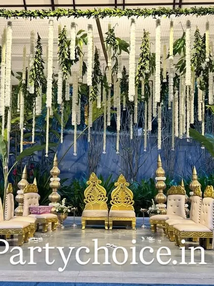 This is a close-up of a modern yet traditional mandap design. We used hanging garlands of white tuberoses and green foliage against a gazebo structure, flanked by banana plants to blend contemporary style with classic wedding elements.