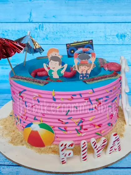 Another angle of the candy pool party cake, showing the fun details like the beach ball and mini umbrellas.