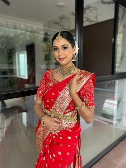 A duplicate image of the model looking radiant in the full traditional bridal attire.