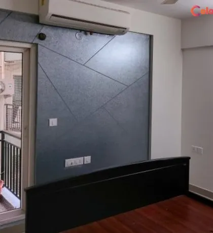 A modern bedroom accent wall featuring a dark, textured finish with clean, geometric lines. This design adds a contemporary and architectural element to the space, perfectly framing the bed area.