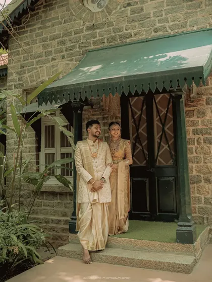 A moment of quiet connection. The couple stands together, their traditional outfits and serene expressions creating a portrait of timeless grace.