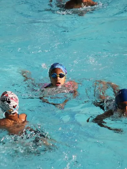 Young swimmers enjoying a lesson during our summer camp, learning new skills in a fun environment.