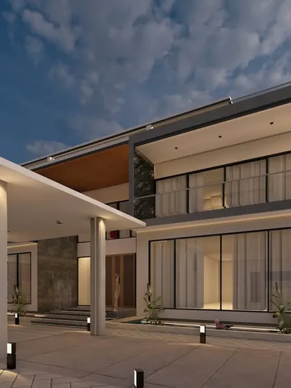 A dusk view of the 'Zen Oasis' entrance. The architectural lighting highlights the strong lines of the portico and the different levels of the home, creating a warm and welcoming ambiance.