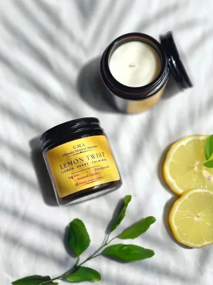 My 'Lemon Twist' Amber Jar Candle, styled with fresh lemon slices. The zesty citrus and calming herb notes are perfect for uplifting your spirits.