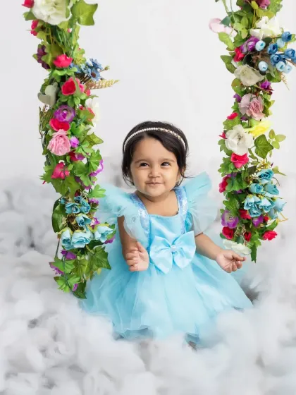 A sweet and gentle smile from the birthday girl during her magical cloud-themed photoshoot.