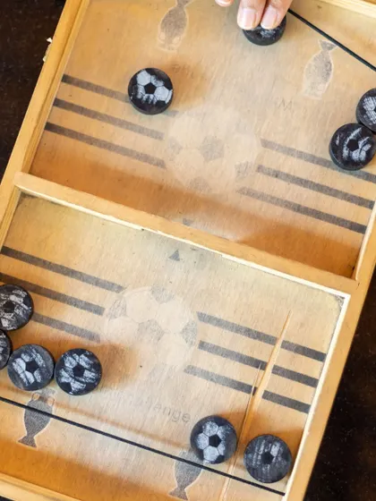 A close-up of the slinger puck board game, a favorite for quick bursts of fun and competition.