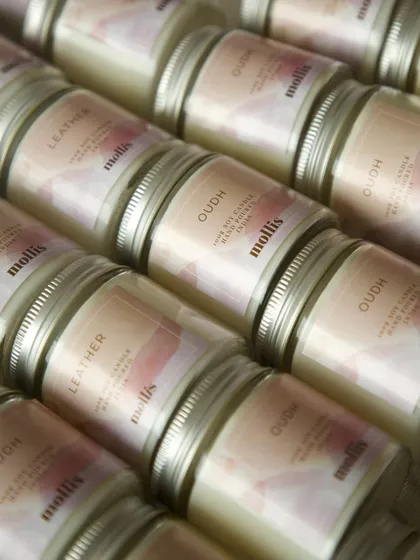 An assortment of the custom candles, showing the different scents chosen for the baby announcement.