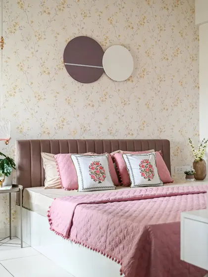 This shot highlights the beautiful bedding and floral-embroidered cushions, which add a traditional, handcrafted touch to the modern room.