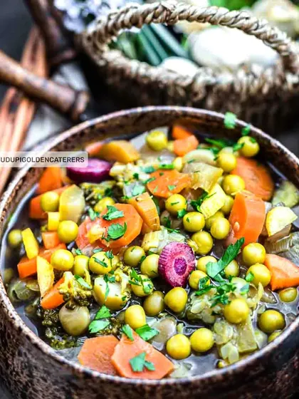 This is our Mixed Vegetable Soup, a hearty and nutritious option packed with peas, carrots, and other seasonal vegetables in a clear broth.