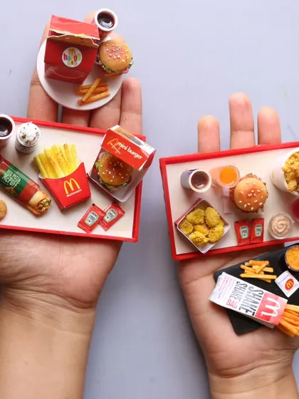 A beautiful image of several completed McDonald's meal trays, showcasing both veg and non-veg options.