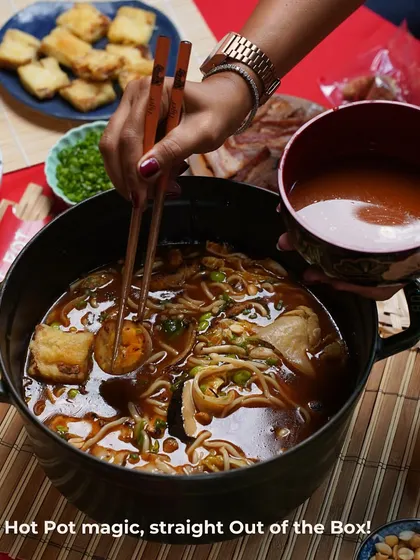Hot Pot magic, straight out of the box. This shot captures the moment of cooking, with chopsticks dipping into the rich broth filled with noodles and other goodies, showing how easy and fun it is to prepare.