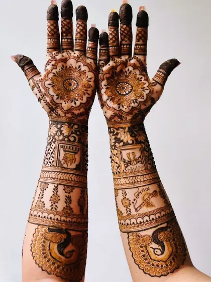 An elegant elbow-length design that is perfect for a bride or for a special occasion. It features traditional elements like peacocks and auspicious wedding symbols.