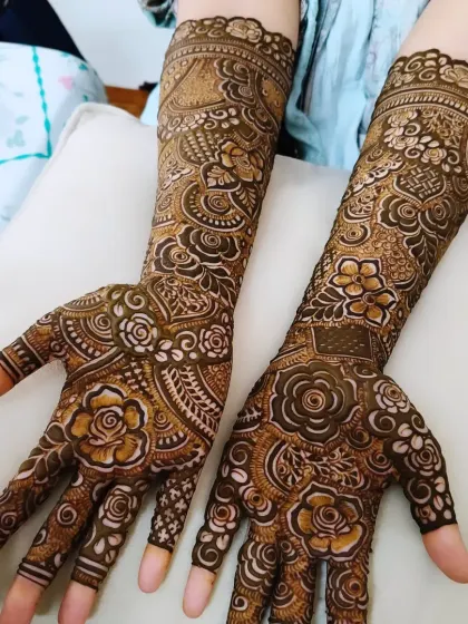 A full-arm bridal design with a beautiful mix of roses, leaves, and swirling patterns. The shading gives the flowers a three-dimensional feel.