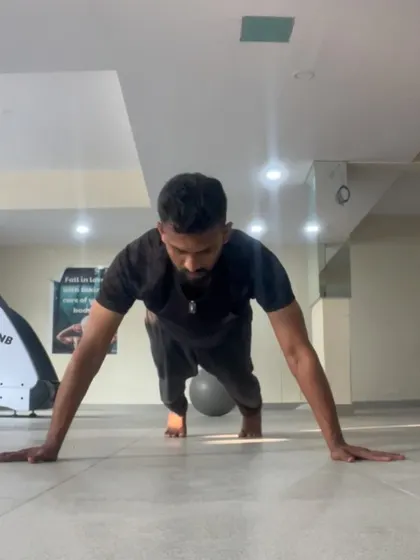 The bottom of a wide pushup, focusing on control and full range of motion. It's not about how many you do, but how well you do them.