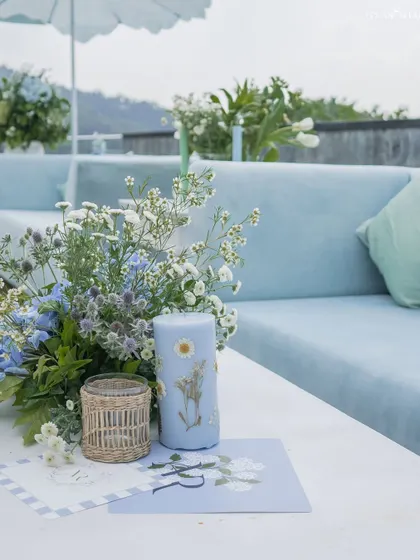 A custom-printed candle and stationery sit on a table at the mountain ceremony, showcasing our attention to personalized details.