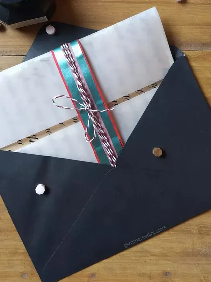 The packaging for the Secret Santa letter. I love wrapping my work, and this one was enclosed in a black envelope and tied with festive ribbon.