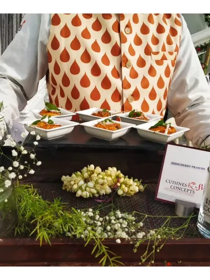Another view of the elegantly presented Tandoori Prawns, showcasing the vibrant colours and fresh floral garnishes on the tray.