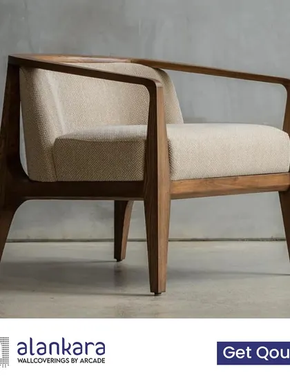 A modern armchair with a low-slung, solid wood frame and comfortable, textured upholstery. A perfect statement piece for a contemporary living room.
