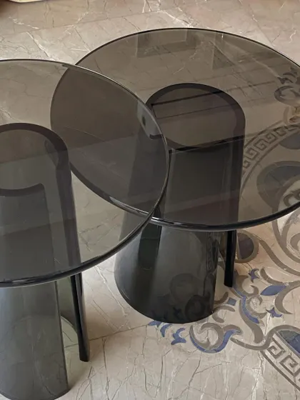 A top-down view of the acrylic tables, highlighting their circular tops and the unique shape of their bases. A sleek and modern choice for any space.