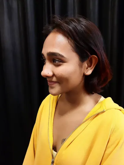 A smiling client with her new, subtle nostril piercing. I aim to make the piercing experience comfortable and positive.
