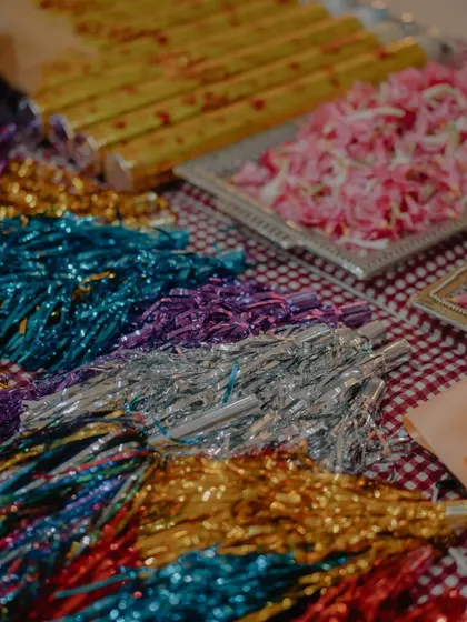 A close-up of the props we use to make our events more fun, including pom-poms, confetti poppers, and flower petals.