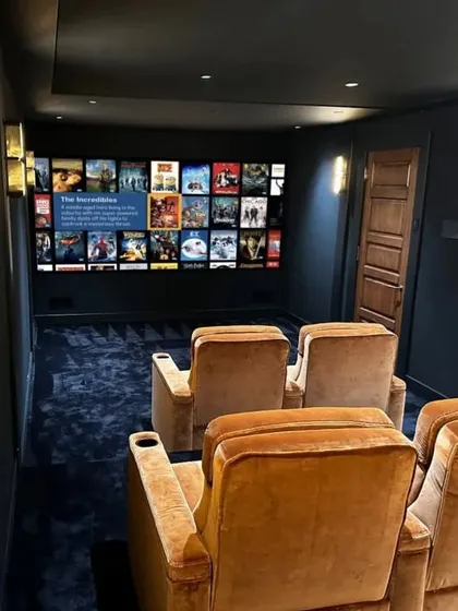 The view from the back row, looking towards the screen. The layout is designed to feel spacious yet intimate, perfect for enjoying a movie with family and friends.