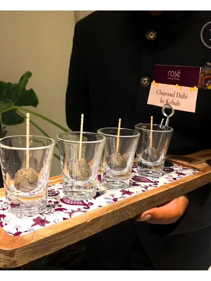 Our innovative Charcoal Dahi Ke Kebab, served in individual shot glasses. The smoky flavor of the charcoal adds a unique twist to this creamy and tangy kebab.