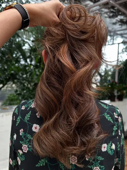 A messy bun style that still shows off the beautiful layers and highlights of the 'Caramello' color.
