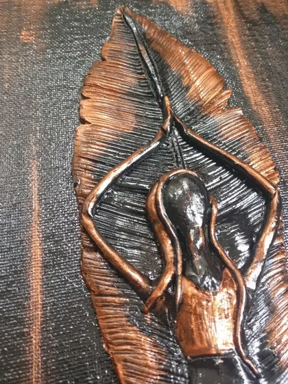 A close-up of the yoga mural painting, showing the texture and metallic sheen.