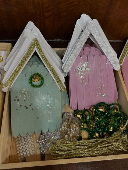 A "frame decorating" activity, where kids could embellish little wooden houses with paint and glitter.