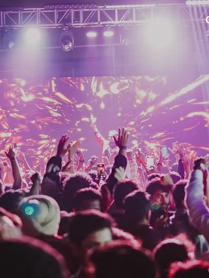 The crowd with hands in the air as the New Year begins. Capturing the peak energy of the celebration is key to showcasing the success of our events.