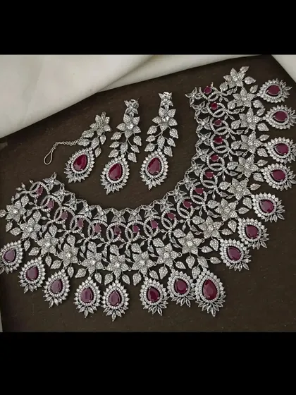 The same stunning CZ floral necklace set, but with deep ruby-red stones. You can rent this to match your outfit perfectly.