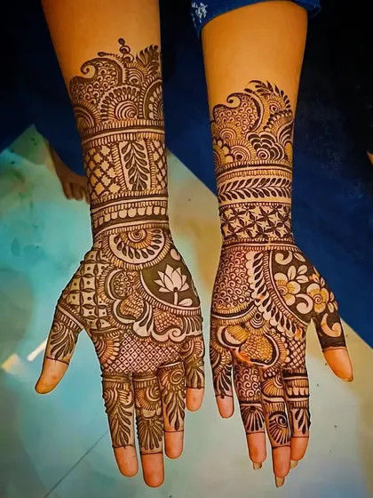 A beautiful design where the lotus is the central focus on the palm, surrounded by delicate and intricate filler patterns.